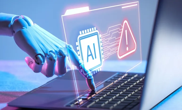 Robotic hand typing on a laptop with a glowing AI chip and warning sign hologram illustrating cybersecurity threats