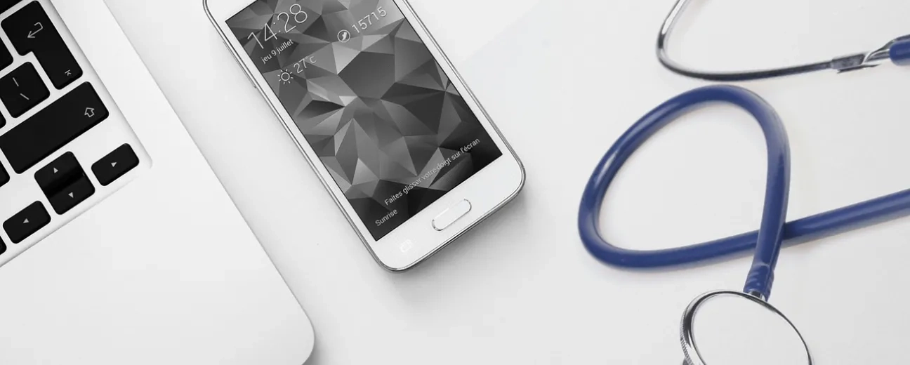 stethoscope near laptop and mobile phone