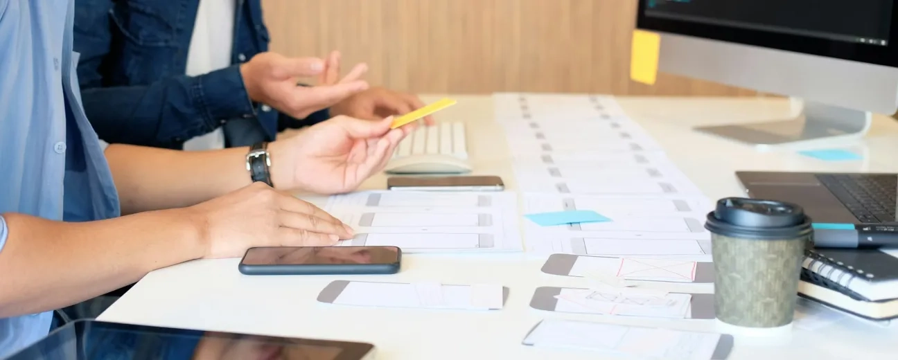 people working with sheets of paper