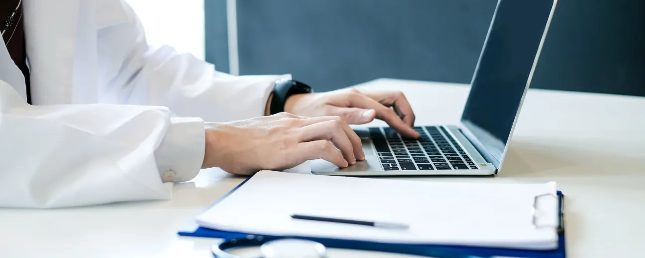 person typing at laptop 