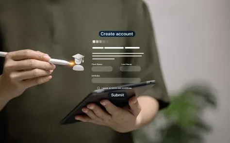 A digital "Create account" form interface is overlaid on a blurred image of hands holding a smartphone and stylus, showing fields for personal information and a graduation cap icon.