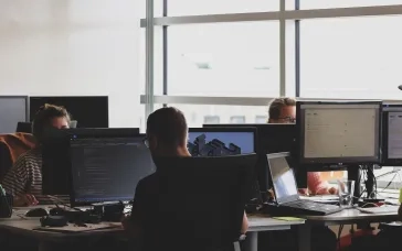 peple sitting on chairs in front of computers