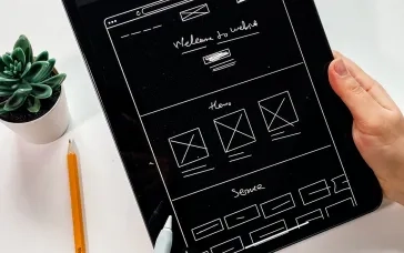 person holding black ipad