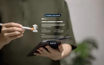 A digital "Create account" form interface is overlaid on a blurred image of hands holding a smartphone and stylus, showing fields for personal information and a graduation cap icon.